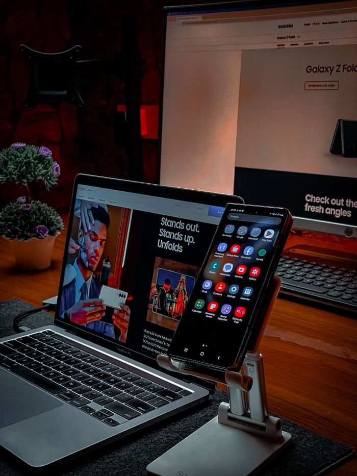 A cozy, modern workspace featuring a laptop and smartphone on a desk, perfect for remote work or digital nomads.